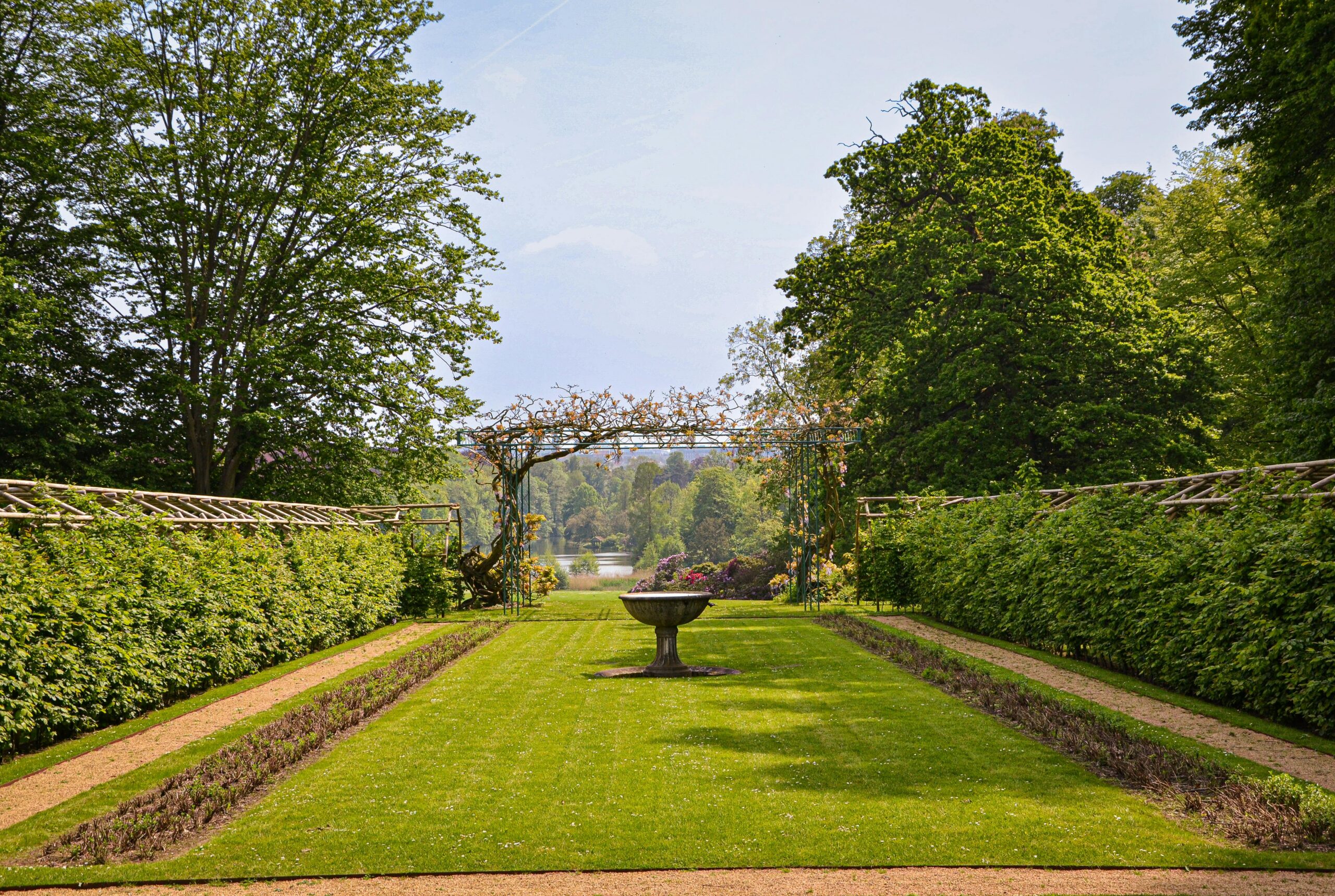 Explore the lush symmetrical garden in summer at Brussels, Belgium under a clear sky.